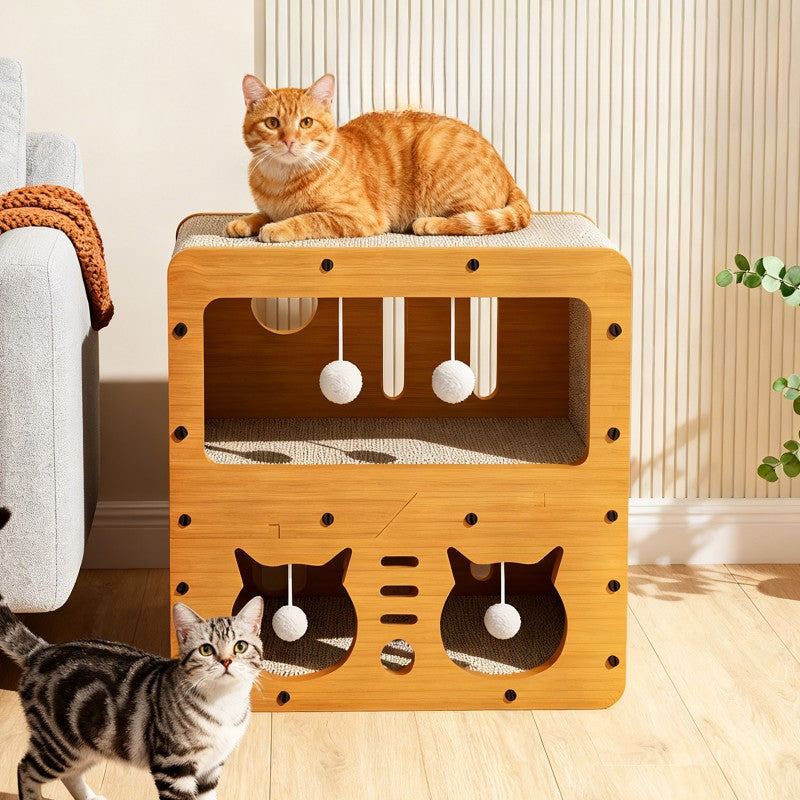 The StayNear Cat Scratcher House beside a sofa in a living room, a ginger cat napping on the top deck and a tabby walking past